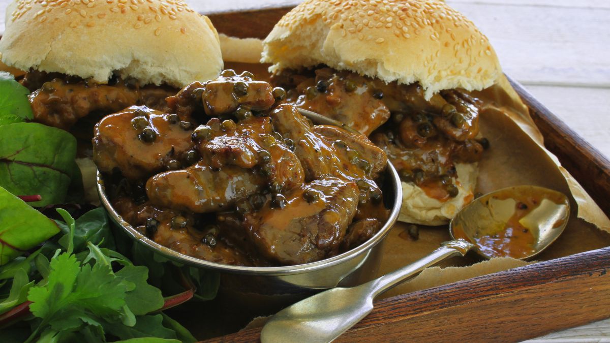 Creamy Peppercorn Sauce over meat in a burger