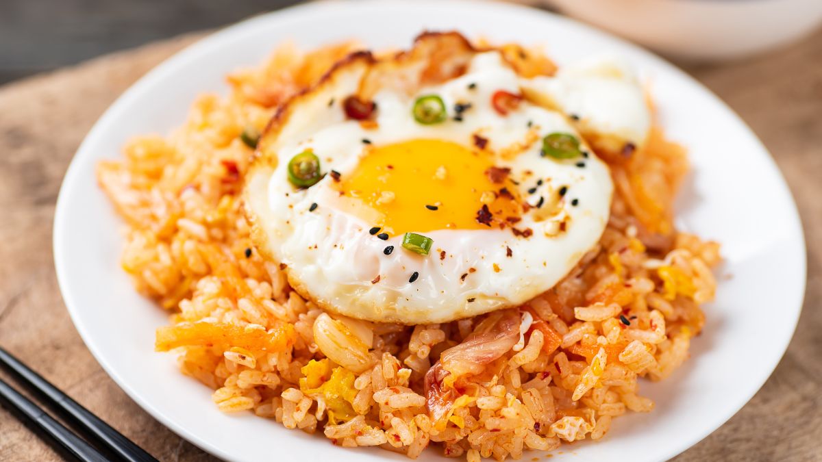 Egg Drop Soup Fried Rice Served on a White Plate With a Fried Egg on Top