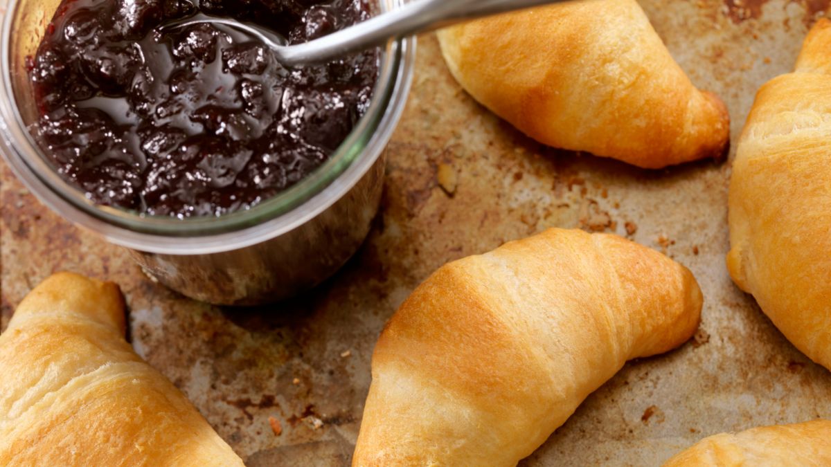 Pillsbury Crescent Rolls served alongside an open jar of sauce with a spoon in it