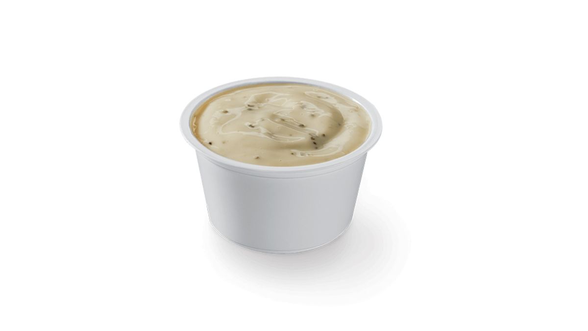 Little Caesars Caesar Dip Ranch in a Plastic Dish on White Background