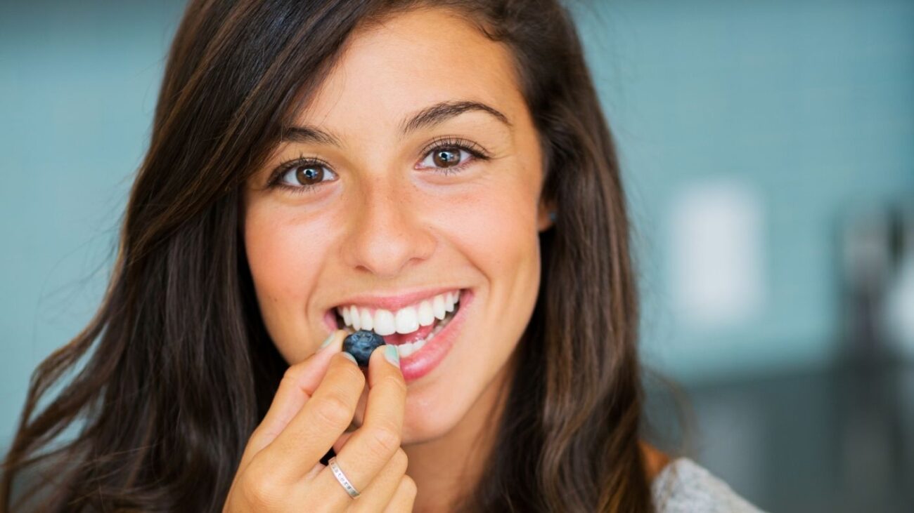 PERSON EATING BLUEBERRIES