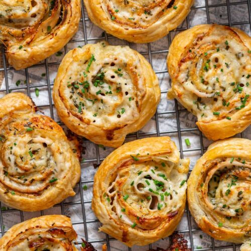 Turkey and cheese puff pastry pinwheels on a cooling rack