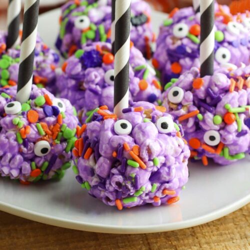 halloween popcorn balls with sticks on plate BoulderLocavore.com