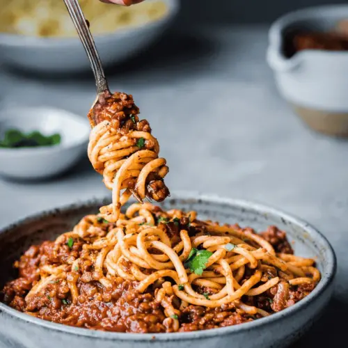 red lentil bolognese twirling pasta