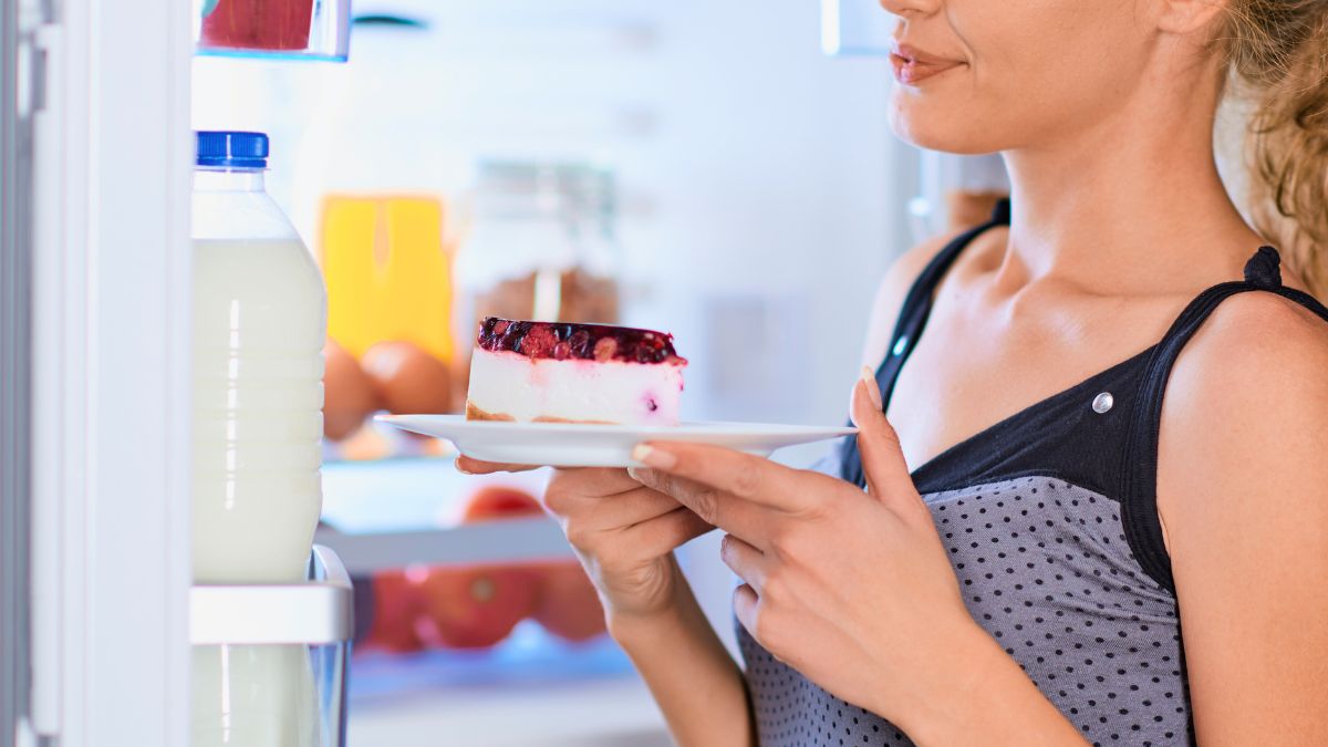 woman putting a piece of cheesecake into the fridge